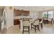 Stylish kitchen with granite counters, stainless appliances, and a dining table with lake views at 24128 Spartina Dr, Venice, FL 34293