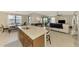 Kitchen island with bar seating and view of the breakfast room and Gathering room at 24128 Spartina Dr, Venice, FL 34293