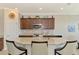 Bright kitchen featuring granite countertops, stainless steel appliances, and breakfast bar at 24128 Spartina Dr, Venice, FL 34293