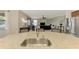 Open kitchen with stainless appliances, breakfast bar and view of the Gathering room at 24128 Spartina Dr, Venice, FL 34293