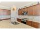 Modern kitchen with stainless steel appliances, granite counters and custom cabinets at 24128 Spartina Dr, Venice, FL 34293