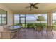 Screened lanai with beautiful lake views and outdoor seating at 24128 Spartina Dr, Venice, FL 34293