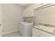 Laundry room with washer, dryer, sink and plenty of storage at 24128 Spartina Dr, Venice, FL 34293