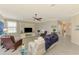Open living room with ceiling fan, built-in entertainment center, and comfortable seating at 24128 Spartina Dr, Venice, FL 34293