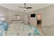 Bedroom featuring a large bed with a seashell-themed comforter and access to an en-suite bathroom at 24128 Spartina Dr, Venice, FL 34293
