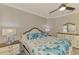 Cozy bedroom features a bed with shell-themed bedding, two nightstands, and a light dresser, creating a coastal retreat at 24128 Spartina Dr, Venice, FL 34293