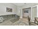 Well-lit office space featuring a gray sofa, workspace, and decor that promotes a productive atmosphere at 24128 Spartina Dr, Venice, FL 34293