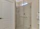 Modern bathroom featuring a walk-in shower with glass doors and tile surround at 24128 Spartina Dr, Venice, FL 34293