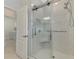 Modern bathroom with glass door shower and white marble tile at 24128 Spartina Dr, Venice, FL 34293