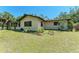 Well-maintained backyard featuring a lush lawn, beautiful landscaping, and an enclosed porch at 2641 Hyde Park St, Sarasota, FL 34239