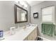 Bathroom featuring a gray wall, a white sink and cabinets, and a large framed mirror at 2641 Hyde Park St, Sarasota, FL 34239