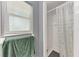 Shower room with tile walls, a shower curtain, and a window at 2641 Hyde Park St, Sarasota, FL 34239