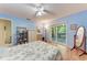 Bright bedroom with light blue walls, a ceiling fan, and sliding doors to a screened porch at 2641 Hyde Park St, Sarasota, FL 34239