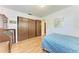 Bedroom with wood floors, closet with sliding doors, and a bureau with drawers at 2641 Hyde Park St, Sarasota, FL 34239