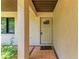 Exterior entryway featuring tiled flooring and a sturdy front door with decorative glass at 2641 Hyde Park St, Sarasota, FL 34239