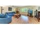 Bright living room with laminate flooring, comfortable seating, and a view of the outdoors at 2641 Hyde Park St, Sarasota, FL 34239