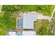 Overhead view of home featuring a private screened-in pool, long driveway, and mature trees at 304 Beach Rd, Venice, FL 34285