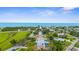 Panoramic aerial view of neighborhood near ocean, highlighting nearby lush green park at 304 Beach Rd, Venice, FL 34285