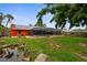 Backyard showcasing a screen enclosed in-ground pool, lush lawn, and privacy fence at 304 Beach Rd, Venice, FL 34285