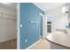 Bathroom featuring large vanity, neutral walls, and doorway to walk-in closet with shelving at 304 Beach Rd, Venice, FL 34285