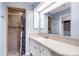 Bathroom featuring vanity with cream countertop, tile shower with decorative mosaic tile, and a framed mirror at 304 Beach Rd, Venice, FL 34285