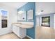 Well-lit bathroom with white vanity and a mirror, next to additional room with sliding glass doors at 304 Beach Rd, Venice, FL 34285