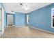 Bright bedroom with a ceiling fan, neutral walls, and a walk-in closet for plenty of storage at 304 Beach Rd, Venice, FL 34285