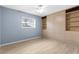 Bedroom featuring large wardrobe with built in shelving and drawers, along with a large window at 304 Beach Rd, Venice, FL 34285