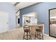 Eat-in kitchen area with breakfast bar, seating, and sliding glass doors leading to outdoor patio at 304 Beach Rd, Venice, FL 34285