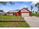 Charming single-story home with a two-car garage, colorful accents, and a well-manicured lawn at 304 Beach Rd, Venice, FL 34285