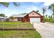 Charming single-story home with a well-maintained lawn, a two-car garage, and attractive landscaping at 304 Beach Rd, Venice, FL 34285