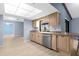 Bright kitchen featuring stainless steel dishwasher, granite countertops, and light wood cabinetry at 304 Beach Rd, Venice, FL 34285