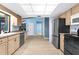 Spacious kitchen with stainless steel refrigerator, black range, and natural light from a large window at 304 Beach Rd, Venice, FL 34285
