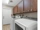 Laundry room with modern white washer and dryer, and storage cabinets above at 304 Beach Rd, Venice, FL 34285