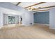 Open living space showcasing wood-look tile flooring and seamless transition to the outdoor patio and pool at 304 Beach Rd, Venice, FL 34285