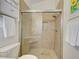 Bathroom featuring a tiled walk-in shower with glass doors and a corner seat at 3192 Pinetree St, Port Charlotte, FL 33952