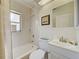 Cozy bathroom featuring a tub-shower combo, vanity, and natural light at 3192 Pinetree St, Port Charlotte, FL 33952