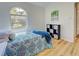 Bedroom featuring wood-look flooring, an arched window, and a storage unit at 3192 Pinetree St, Port Charlotte, FL 33952