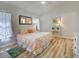 Inviting bedroom features hardwood floors, soft lighting, and tasteful decor for a relaxing and comfortable atmosphere at 3192 Pinetree St, Port Charlotte, FL 33952