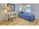 Cozy bedroom with wood-look flooring, natural light and a quaint writing desk at 3192 Pinetree St, Port Charlotte, FL 33952