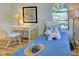 Charming bedroom featuring wood-look flooring, arched windows and a writing desk at 3192 Pinetree St, Port Charlotte, FL 33952