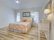 Spacious bedroom with wood floors and natural light, providing a peaceful sanctuary for rest and rejuvenation at 3192 Pinetree St, Port Charlotte, FL 33952