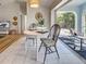 Sunlit dining area with a round table and chairs, offering a seamless transition to the outdoor patio at 3192 Pinetree St, Port Charlotte, FL 33952