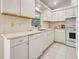 Well-lit kitchen with white cabinets, modern countertops, and updated appliances, creating a clean, inviting space at 3192 Pinetree St, Port Charlotte, FL 33952