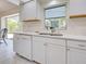 Bright kitchen offering modern appliances, stylish countertops, and a view to the outdoors, perfect for everyday living at 3192 Pinetree St, Port Charlotte, FL 33952