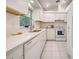 Modern kitchen featuring white cabinetry, quartz countertops, and stainless steel appliances for a sleek, contemporary look at 3192 Pinetree St, Port Charlotte, FL 33952