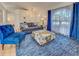 Spacious living room features built in shelving, bright window, and stylish modern furniture at 3192 Pinetree St, Port Charlotte, FL 33952