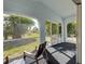 Comfortable screened porch with seating to relax and enjoy the outdoors at 3192 Pinetree St, Port Charlotte, FL 33952
