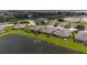 Beautiful aerial view of homes backing onto a serene lake and lush green lawns at 3419 Lakewood Blvd, North Port, FL 34287