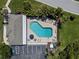 Aerial view of a community pool with parking, seating, and a manicured landscape at 3419 Lakewood Blvd, North Port, FL 34287